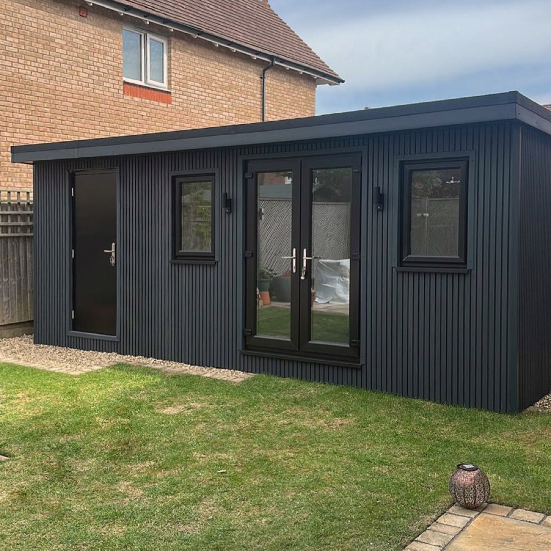 Custom-built garden room clad in anthracite composite