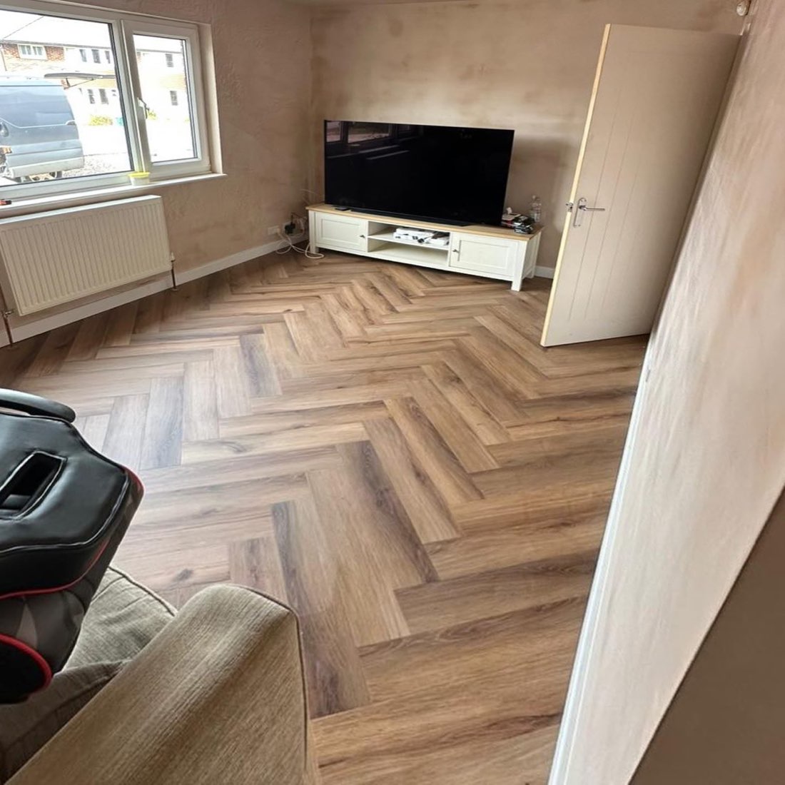 Oak-effect herringbone LVT flooring in a living room