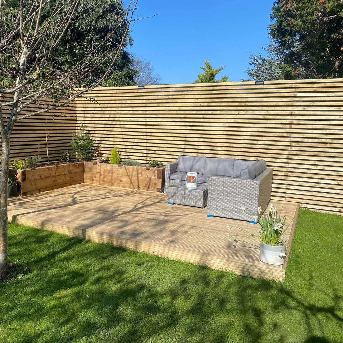 Raised garden deck with sleeper planters and seating