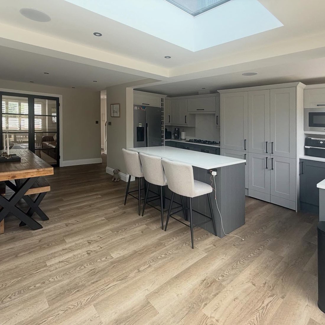 Bright open-plan kitchen diner with island and skylight